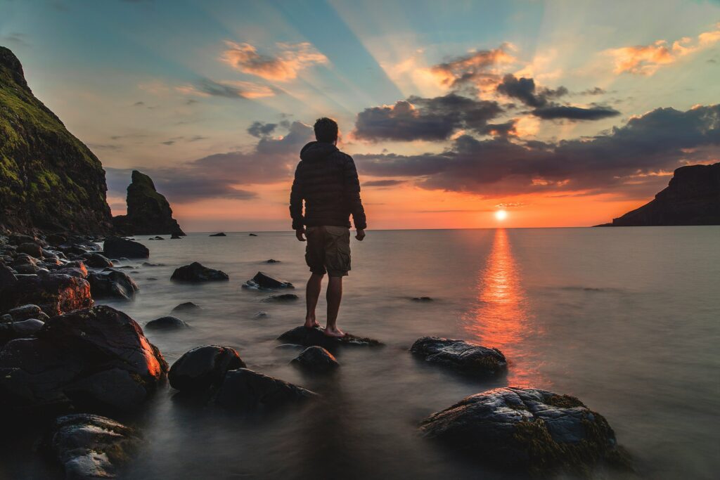 A man, looking at a sunrise.